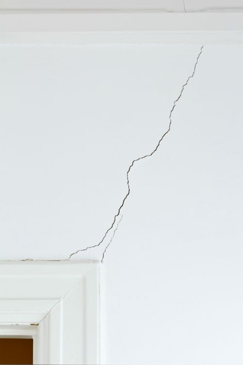 Interior wall crack above door frame in Canadian home