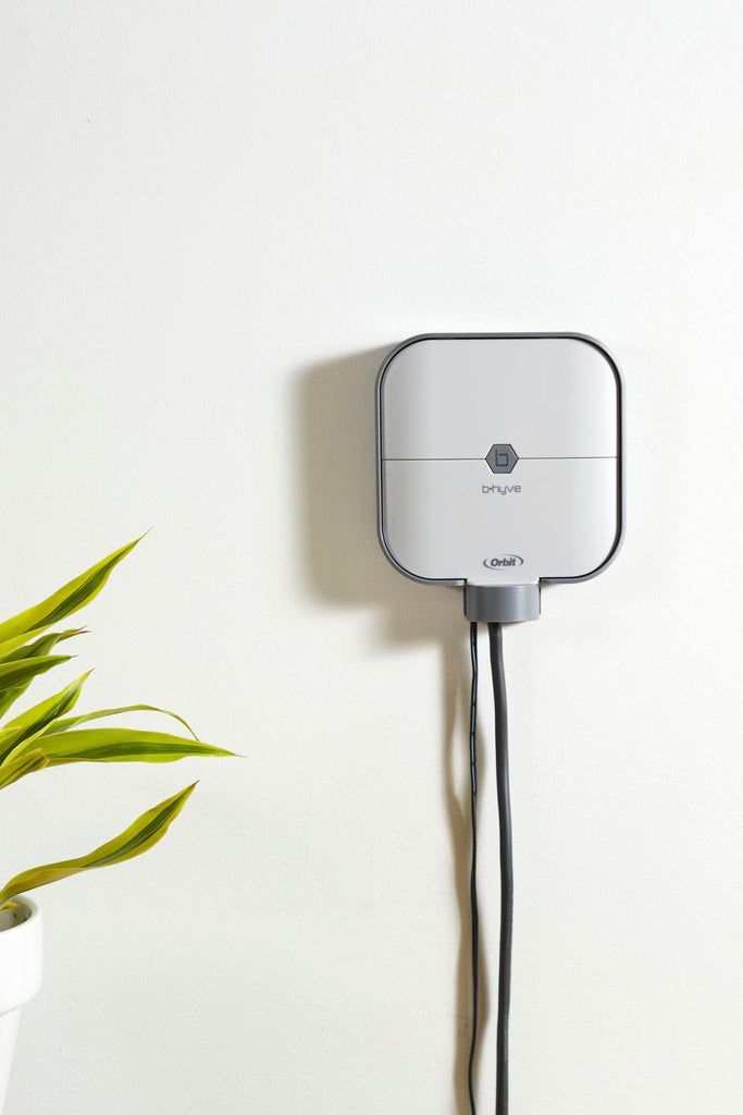 Smart irrigation controller device mounted on wall for gardens